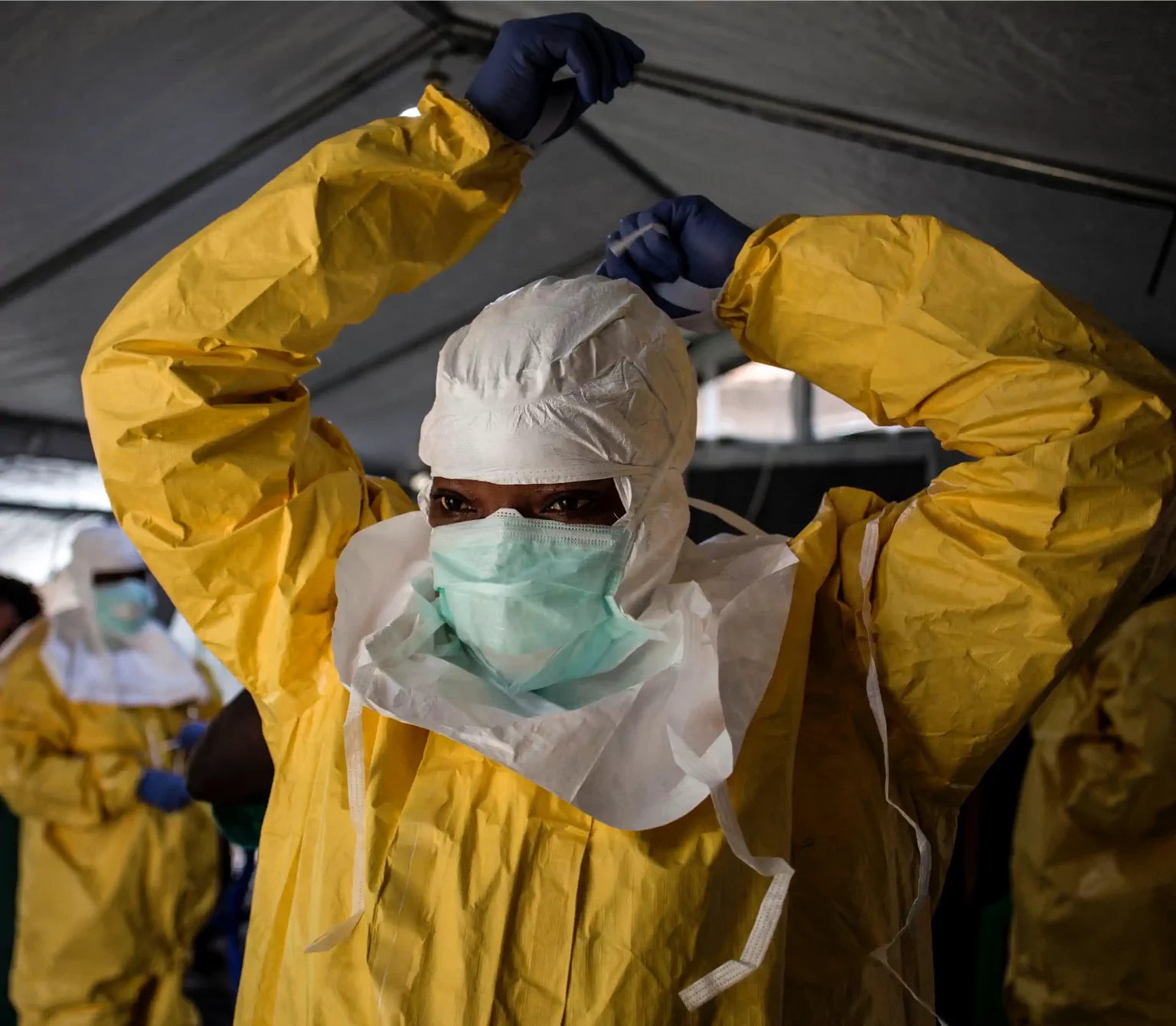 A medical worker puts on her Personal Protective Equipment (PPE) ahead of entering an Ebola Treatment Centre