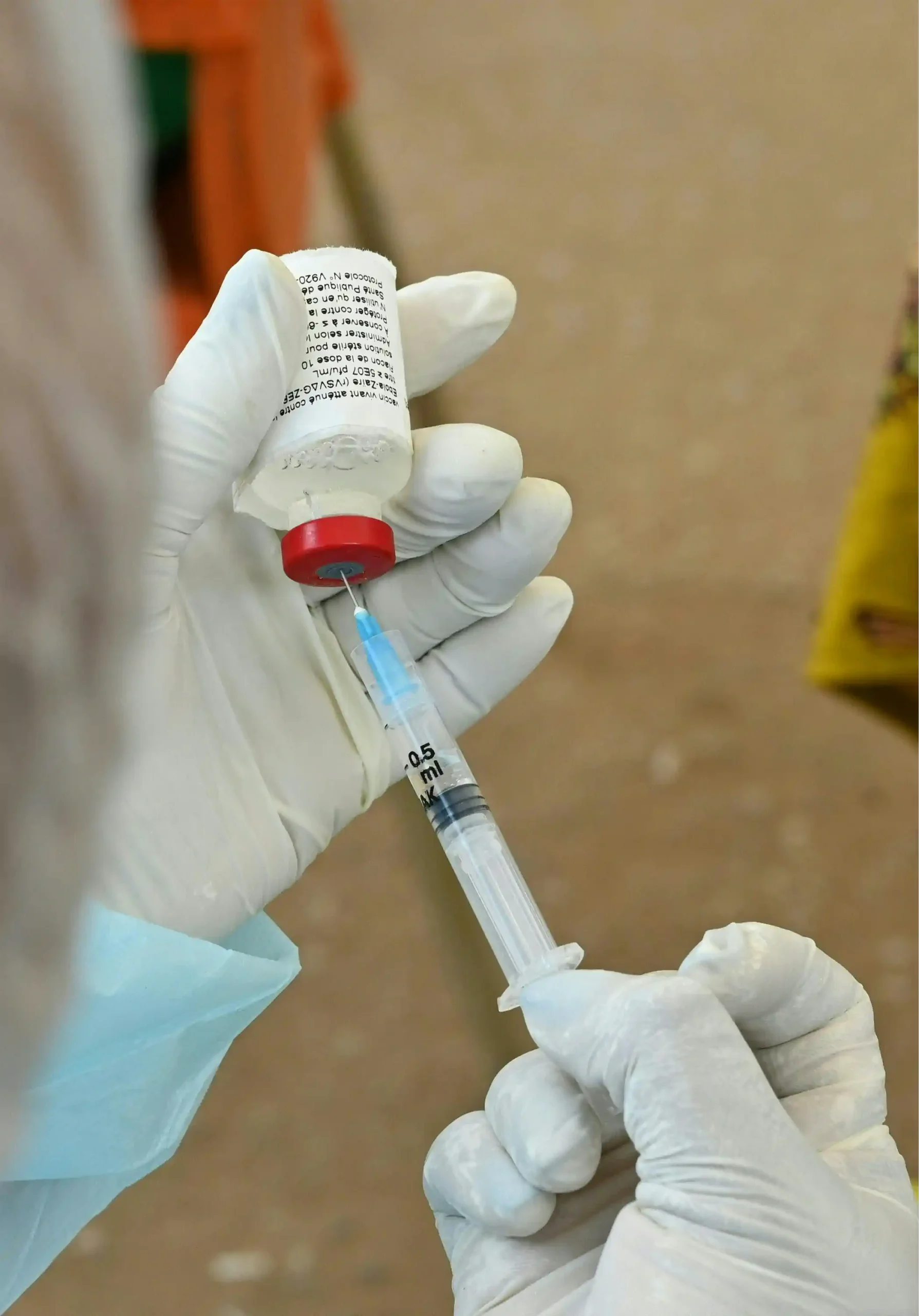 A health worker preparing a dose of Ebola vaccine