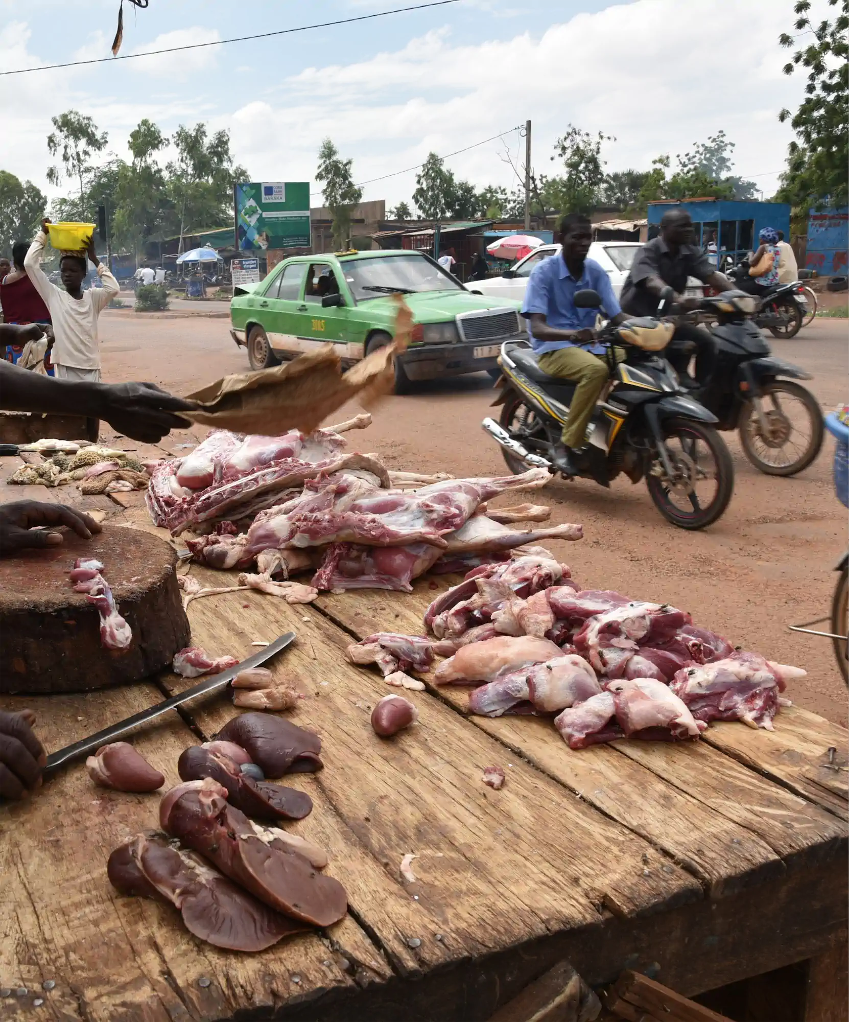 Butchers working beside a street in Ouagadougou